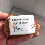 Een slagroomtaartje met marsepeinlaagje waarop het logo van OMOsgHelmond staat en de tekst "Bedankt voor je inzet".